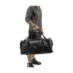 Man carrying the RYZVOX FAR Duffel Bag 40L Travel by the top handles