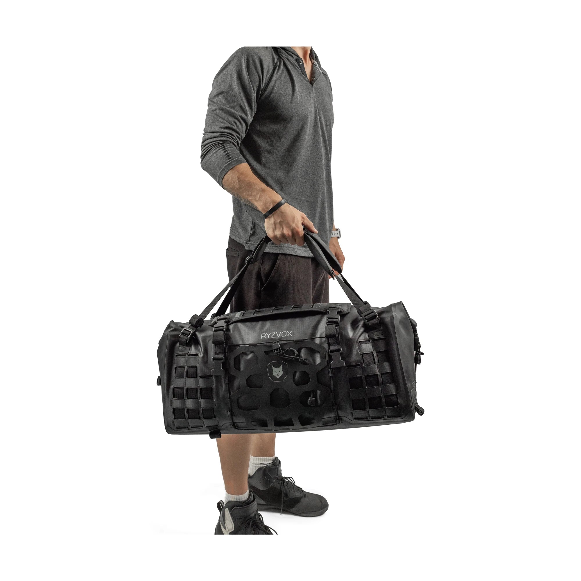 Man carrying the RYZVOX FAR Duffel Bag 40L Travel by the top handles