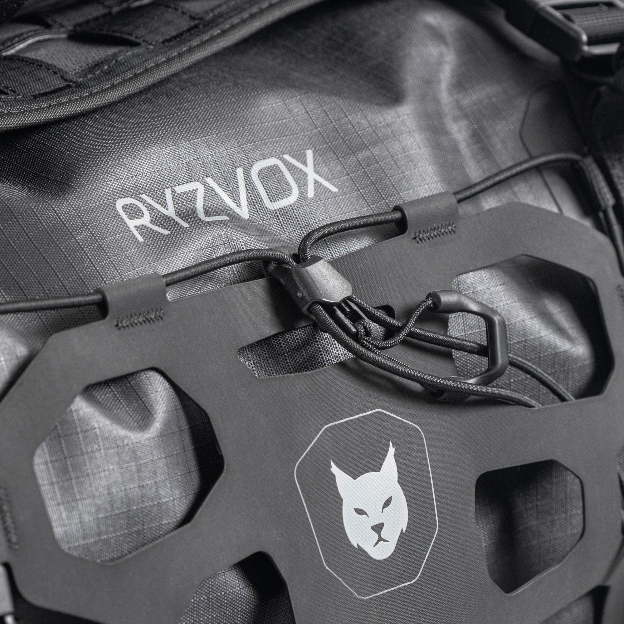 Close up of the front panel with the lynx crest and the elastic cargo net