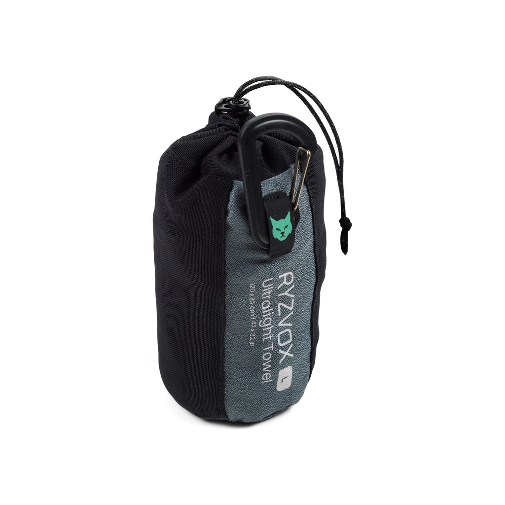 RYZVOX Ultralight Towel L packed upright in its stuff sack with the product label