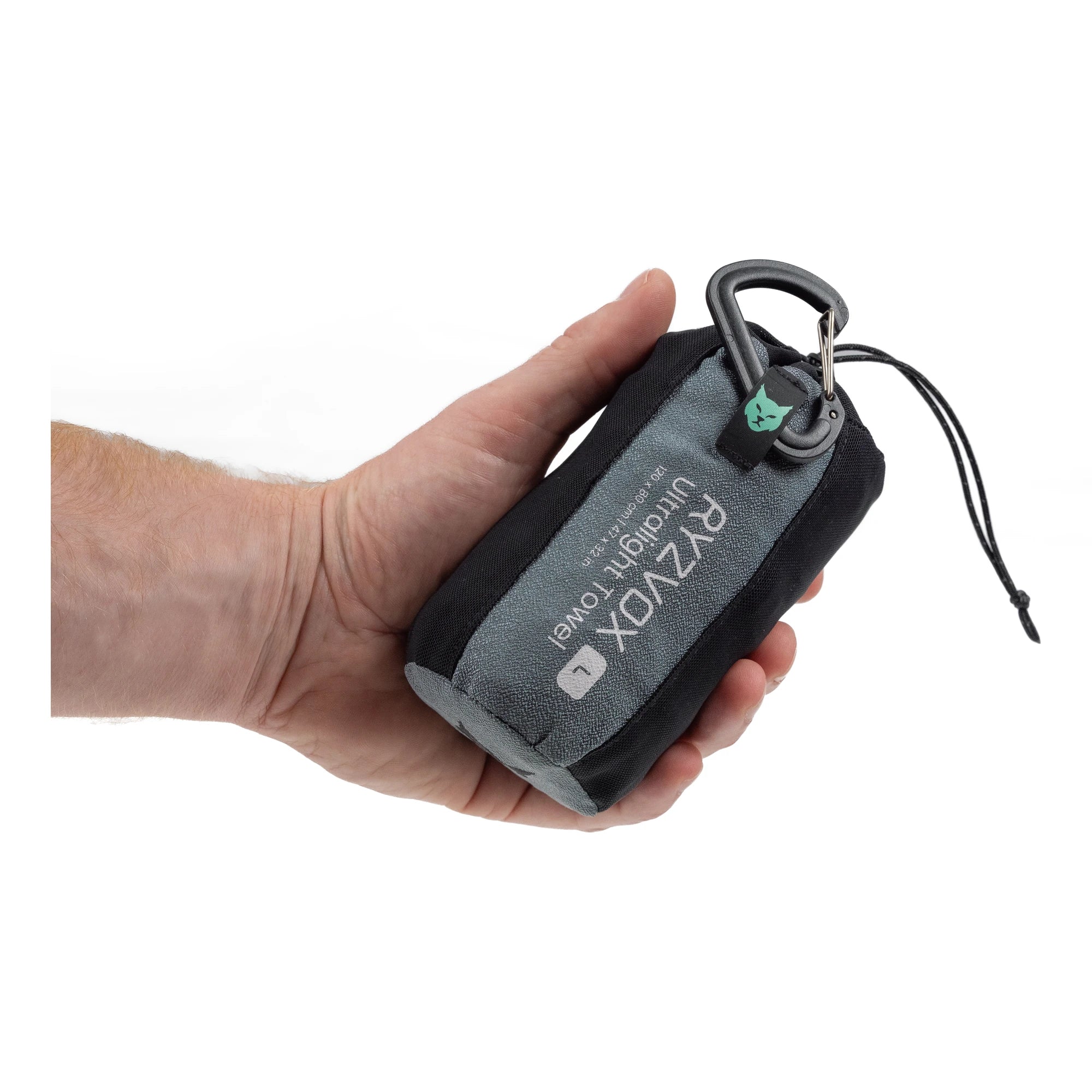 RYZVOX Ultralight Towel L packed in its stuff sack, held in one hand to show the size